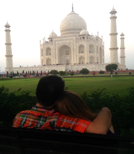 The happy couple relaxing on a bench overlooking the Taj Mahal